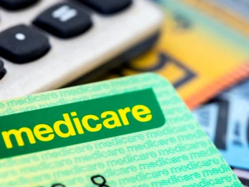 Image os a Medicare card on a calculator and Australian dollar notes