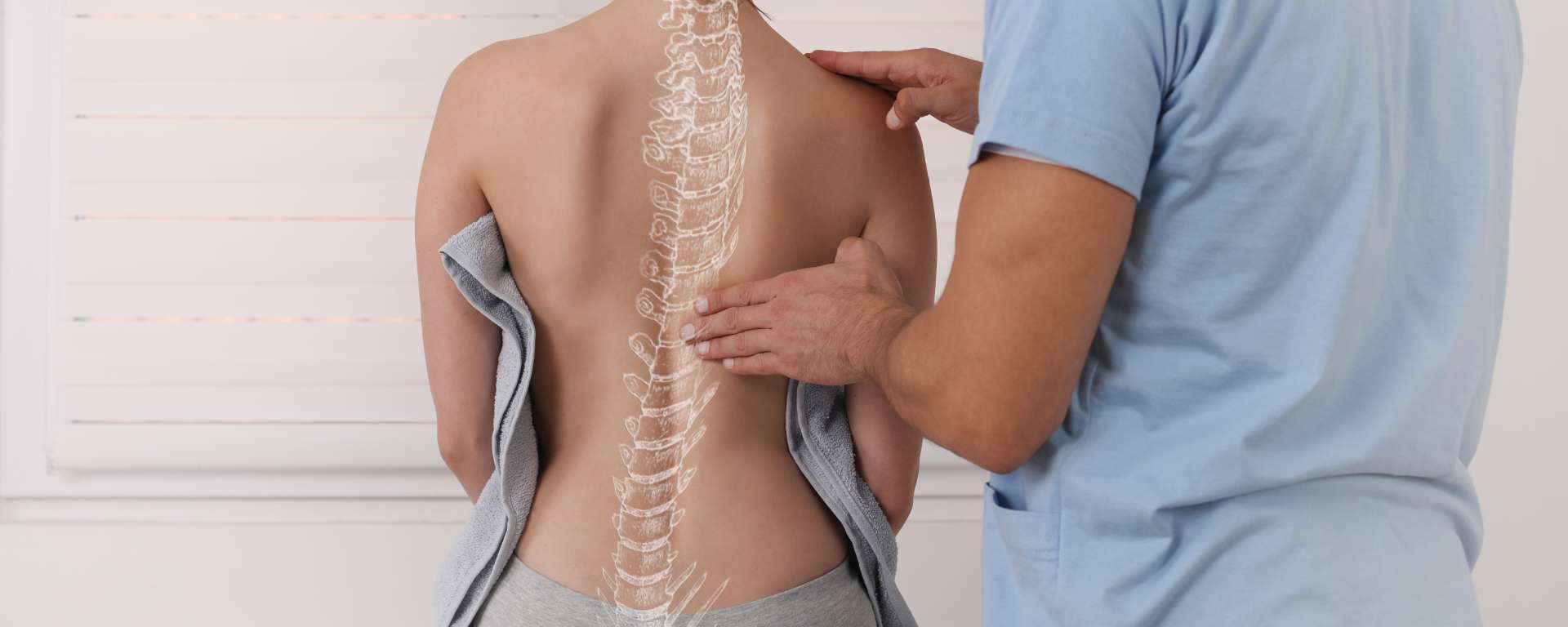 Physio, chiro or osteo Health professional looking at a patient's back with graphic of spine superimposed » HCi