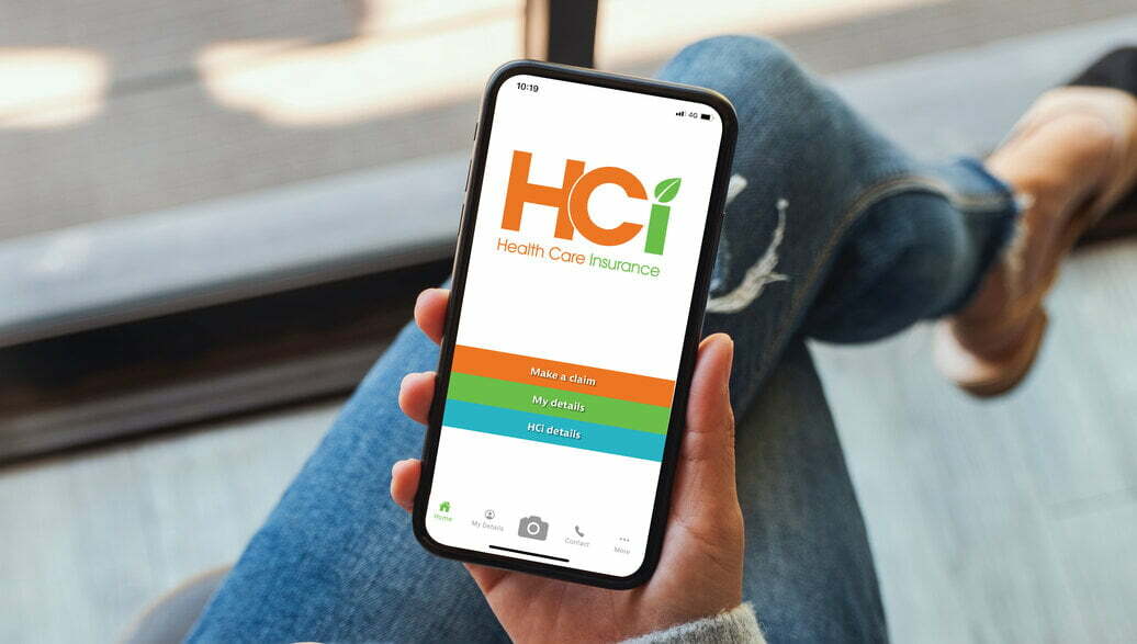 HCi claiming app open on a mobile phone in a woman's hand