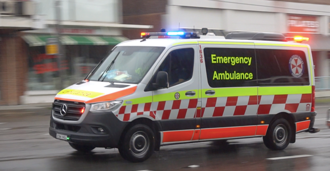Ambulance driving along an Australian city street