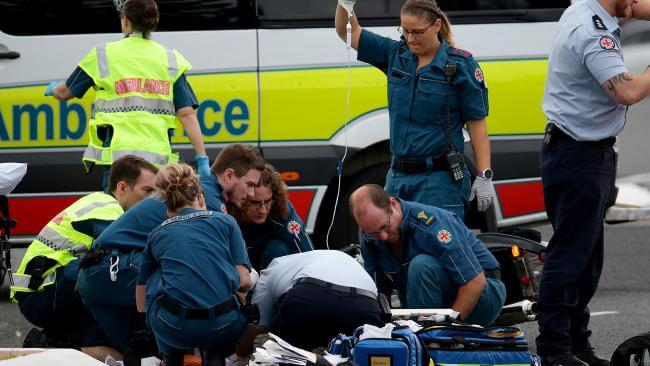 Paramedics helping an emergency patient beside an ambulance - understand ambulance cover across Australia » HCi