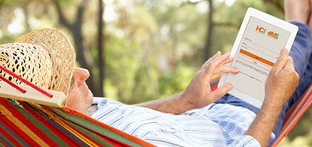Man relaxing in a hammock while looking at OMS, the secure HCi member portal - a great tool for claiming health cover » HCi